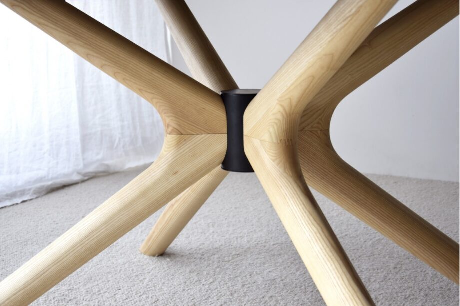 Mesa de comedor oval de sobre cerámico gris con patas fresno